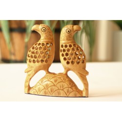 Pair of lattice style carved parrots sitting on a carved mount facing each other