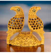 Pair of lattice style carved parrots sitting on a carved mount.
