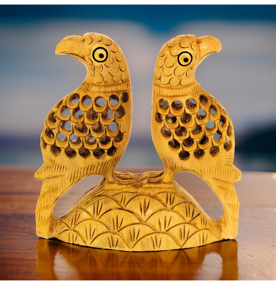 Pair of lattice style carved parrots sitting on a carved mount.